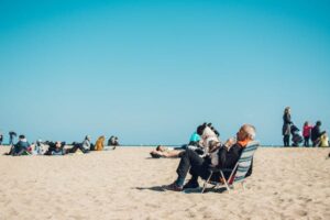 guy sitting in chair on the beach